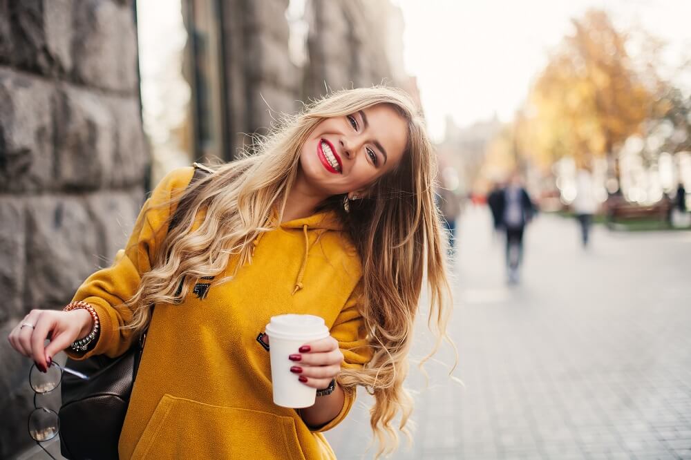 girl smiling in yellow hoodie